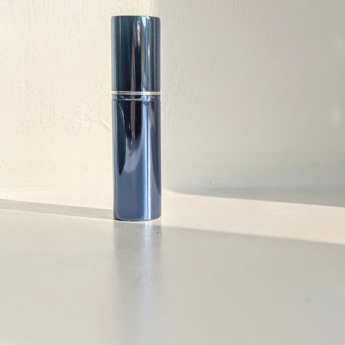 shinny blue halo 5ml easy fill perfume atomizer spray with lid on on surface