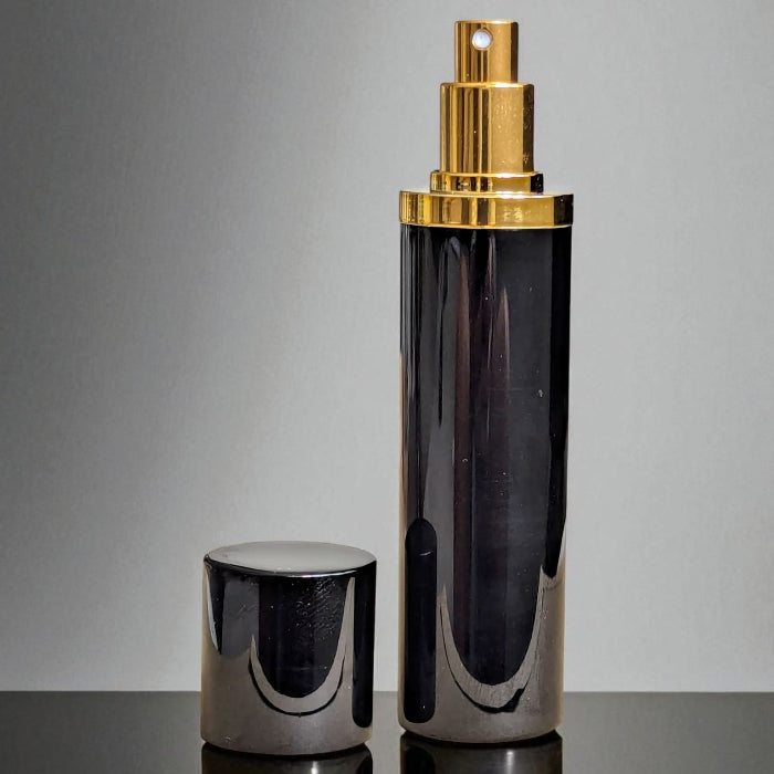 essential atomizer magnifico black and gold 10ml perfume atomizer with lid off on surace