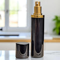  black and gold 10ml perfume atomizer with lid off on marble surface