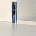 shinny blue halo 5ml easy fill perfume atomizer spray with lid on on surface