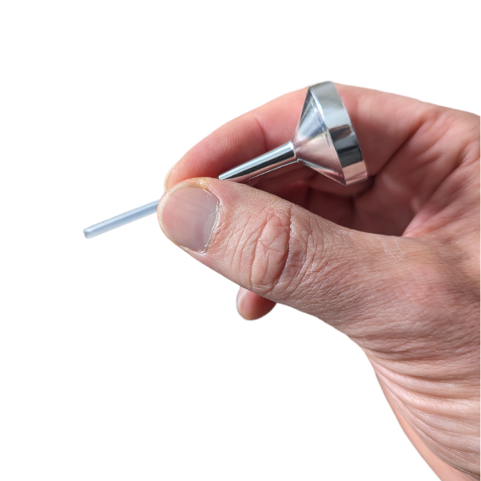 small metal filling funnel with extension tip in someone's hand to show size on white background