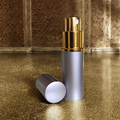 lavender perfume atomizer on gold surface with lid off