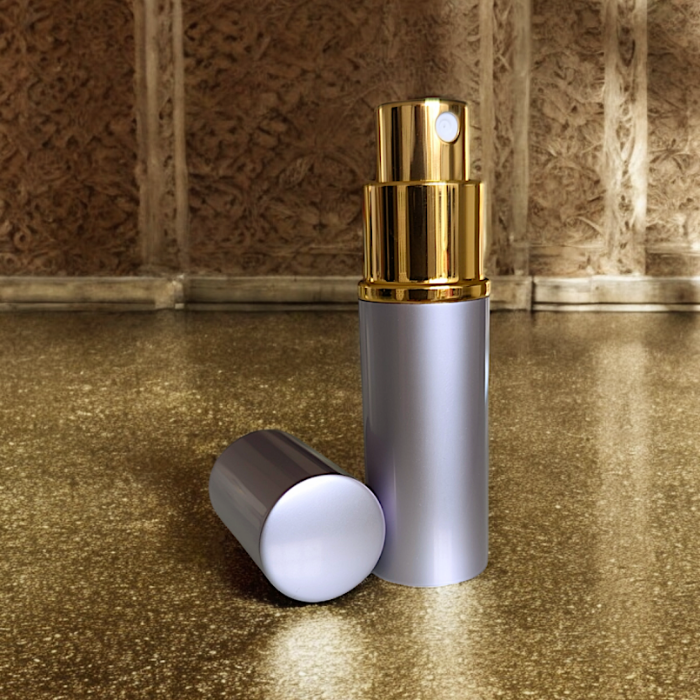 lavender perfume atomizer on gold surface with lid off