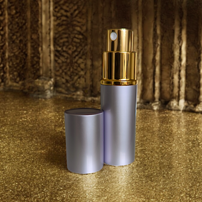 lavender perfume atomizer on gold surface with lid off