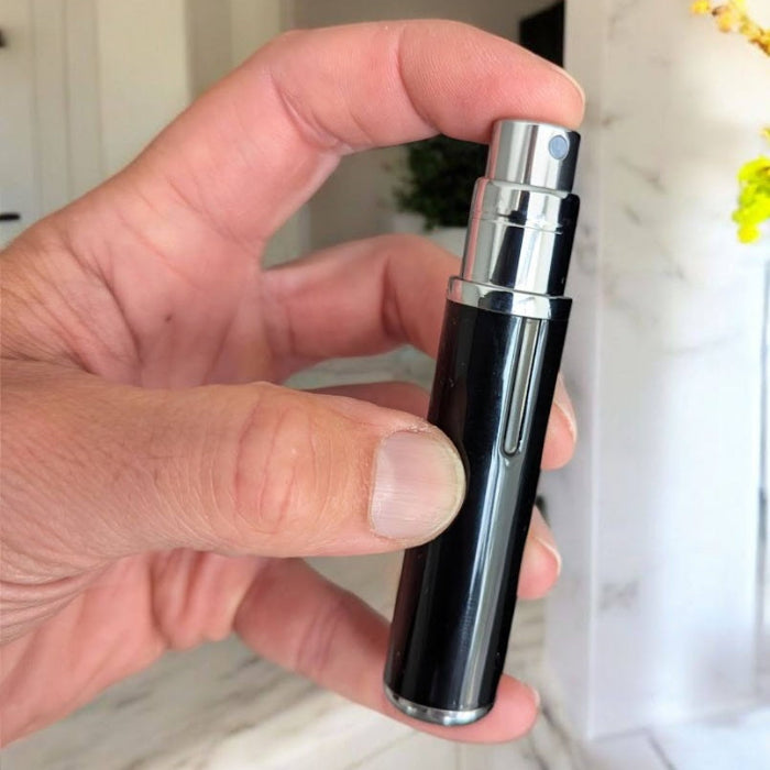 essential atomizer vapora 5ml luxury easy fill perfume atomizer in black in human hand ready to spray