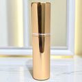 gold easy fill perfume atomizer on marble surface