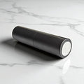 essential atomizer easy fill black twist up 8ml with silver spray head on flat surface