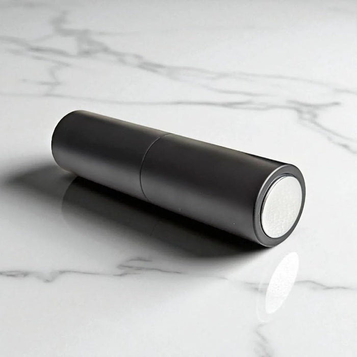 essential atomizer easy fill black twist up 8ml with silver spray head on flat surface